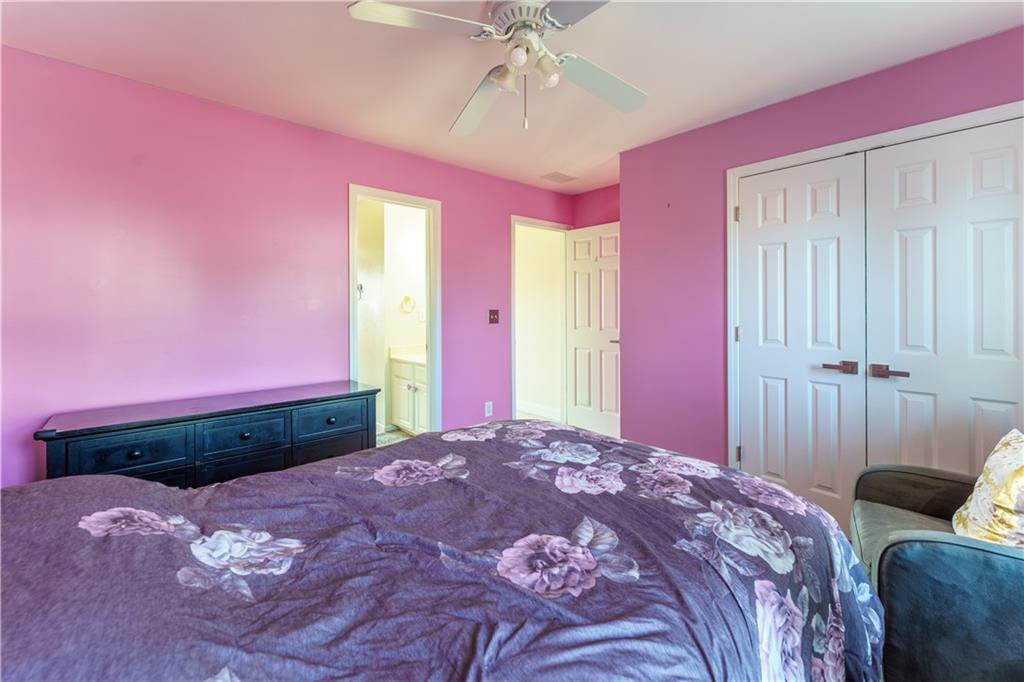 976 Redstone Road Dacula, GA 30019 - Photo 42 of 43 a bedroom with a bed and a mirror