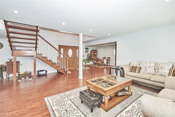 a living room with furniture and a table with wooden floor