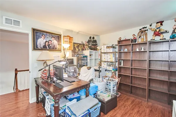 a living room with furniture a rug and a bookshelf