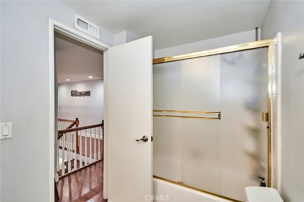 a bathroom with a glass shower door