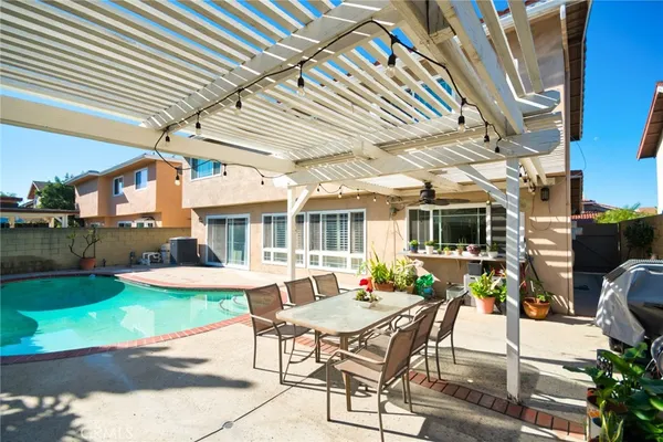 a view of a patio with table and chairs and potted plants
