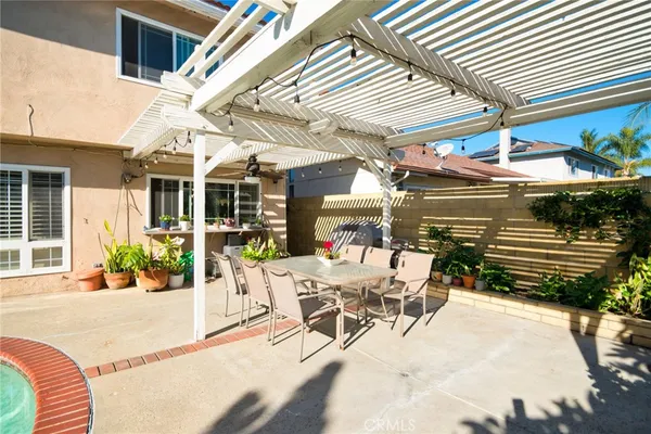 a view of a patio with a table and chairs and potted plants