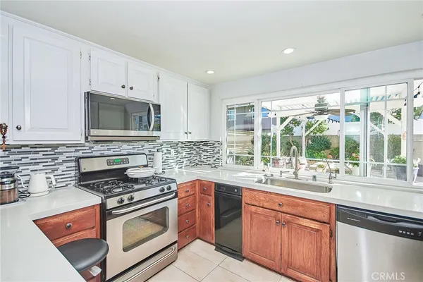 a kitchen with stainless steel appliances a stove sink and cabinets
