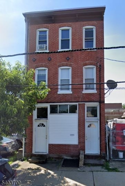 a view of a house with a yard and garage