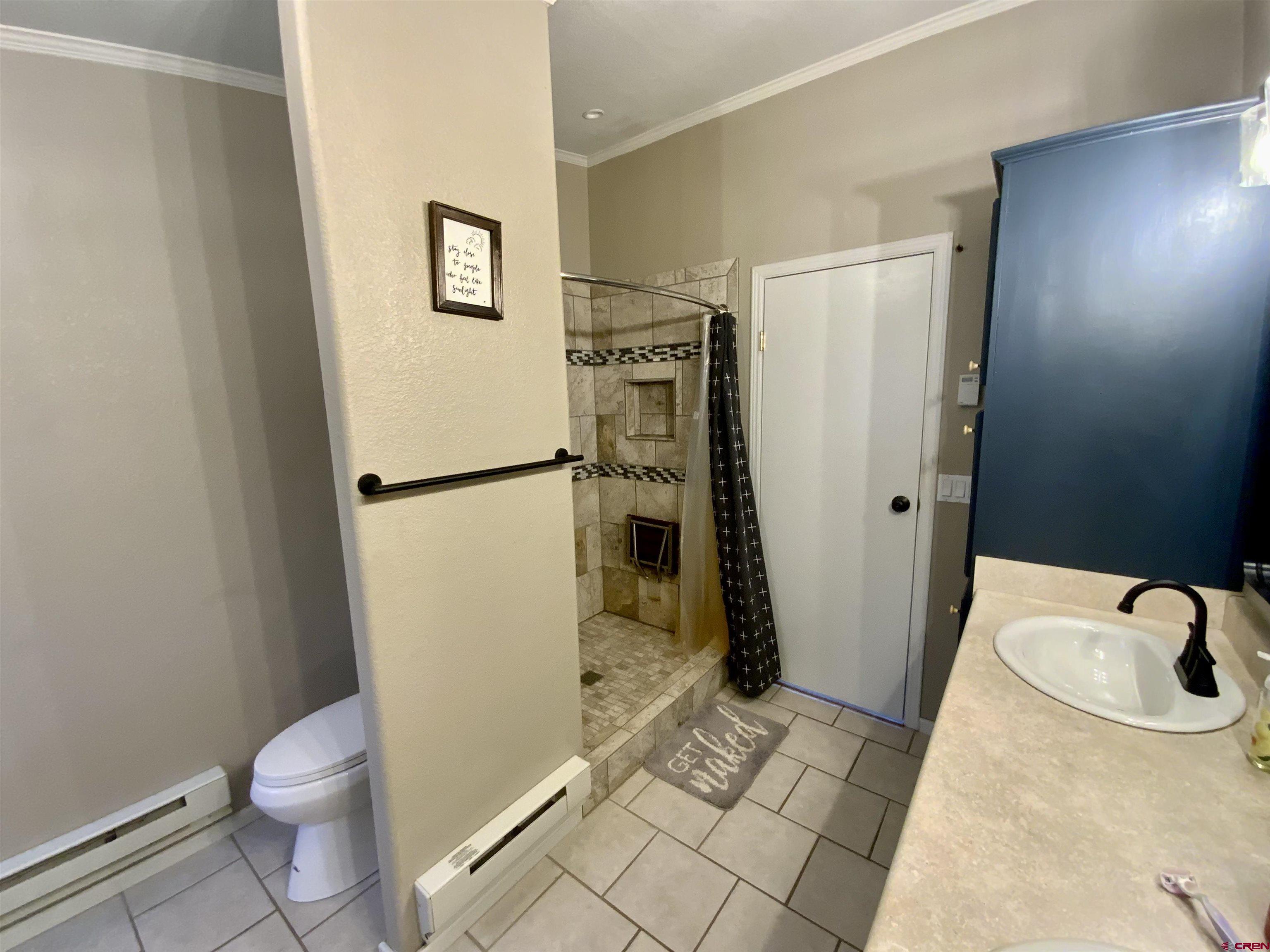 13 Ridge Lane Gunnison, CO 81230 - Photo 14 of 24 a bathroom with a sink toilet and shower