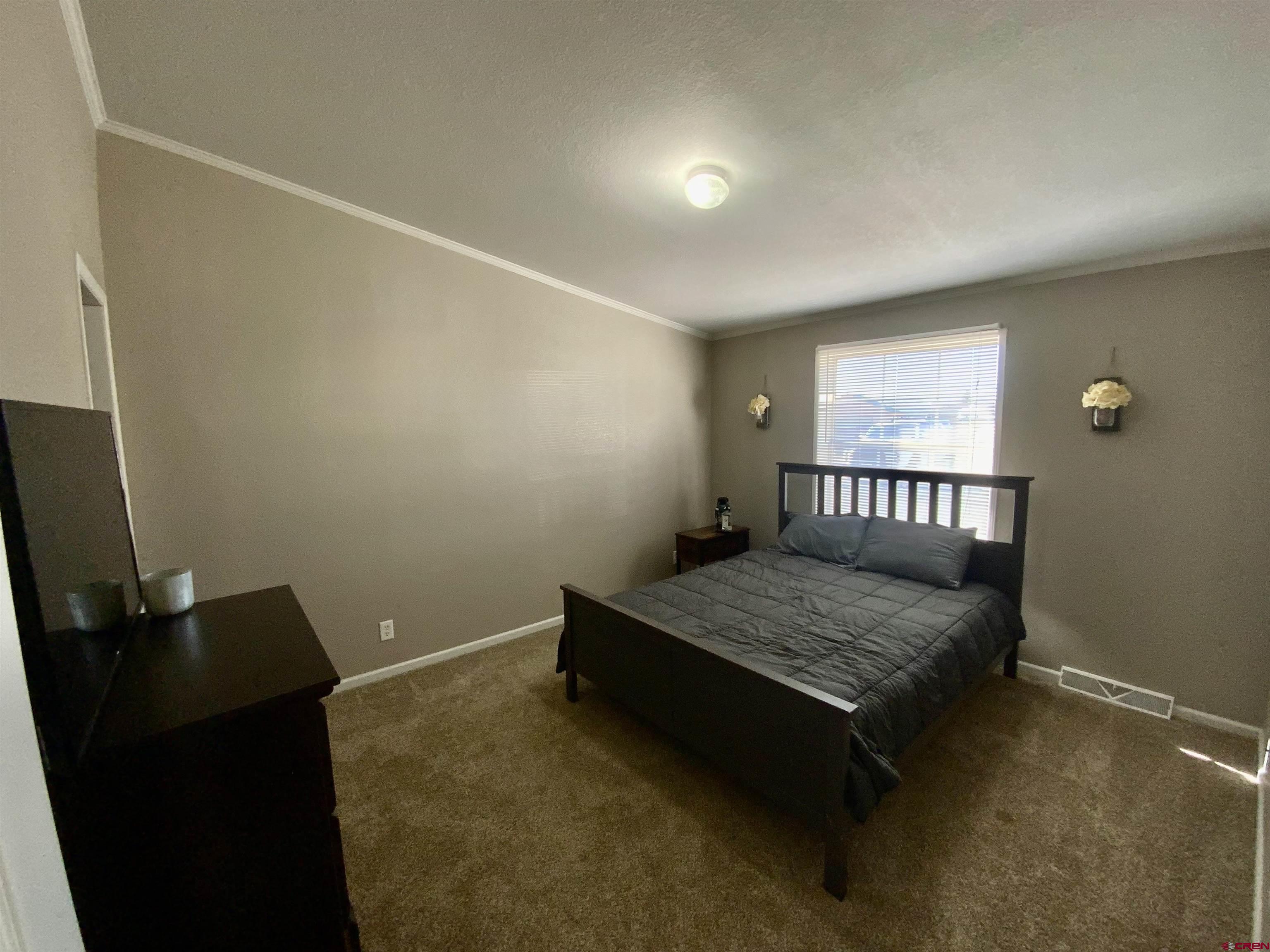 13 Ridge Lane Gunnison, CO 81230 - Photo 17 of 24 a bedroom with a bed and wooden floor