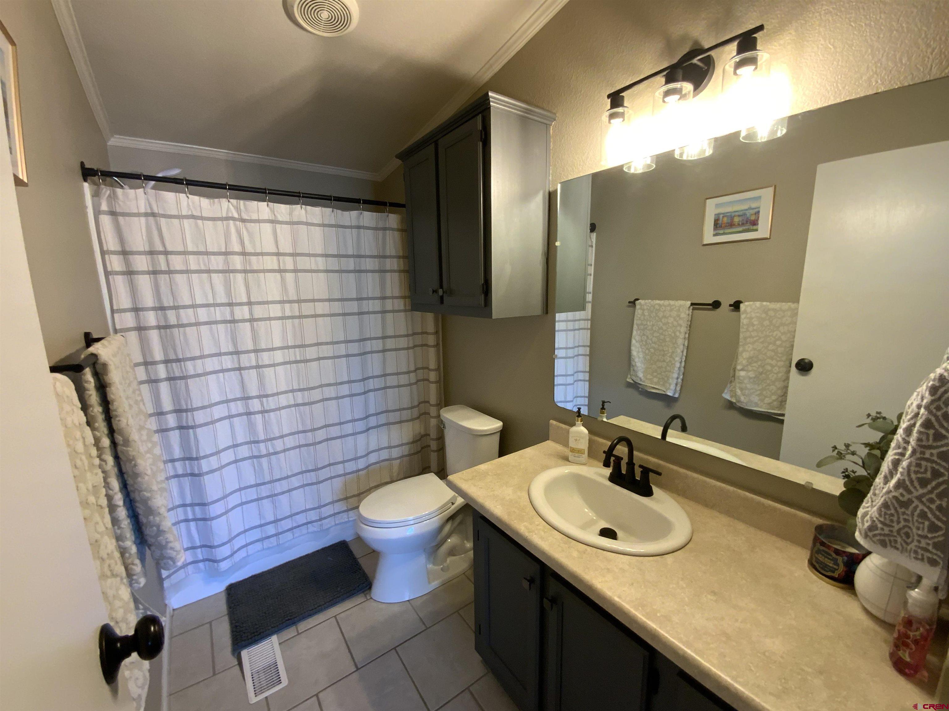 13 Ridge Lane Gunnison, CO 81230 - Photo 18 of 24 a bathroom with a sink and a mirror