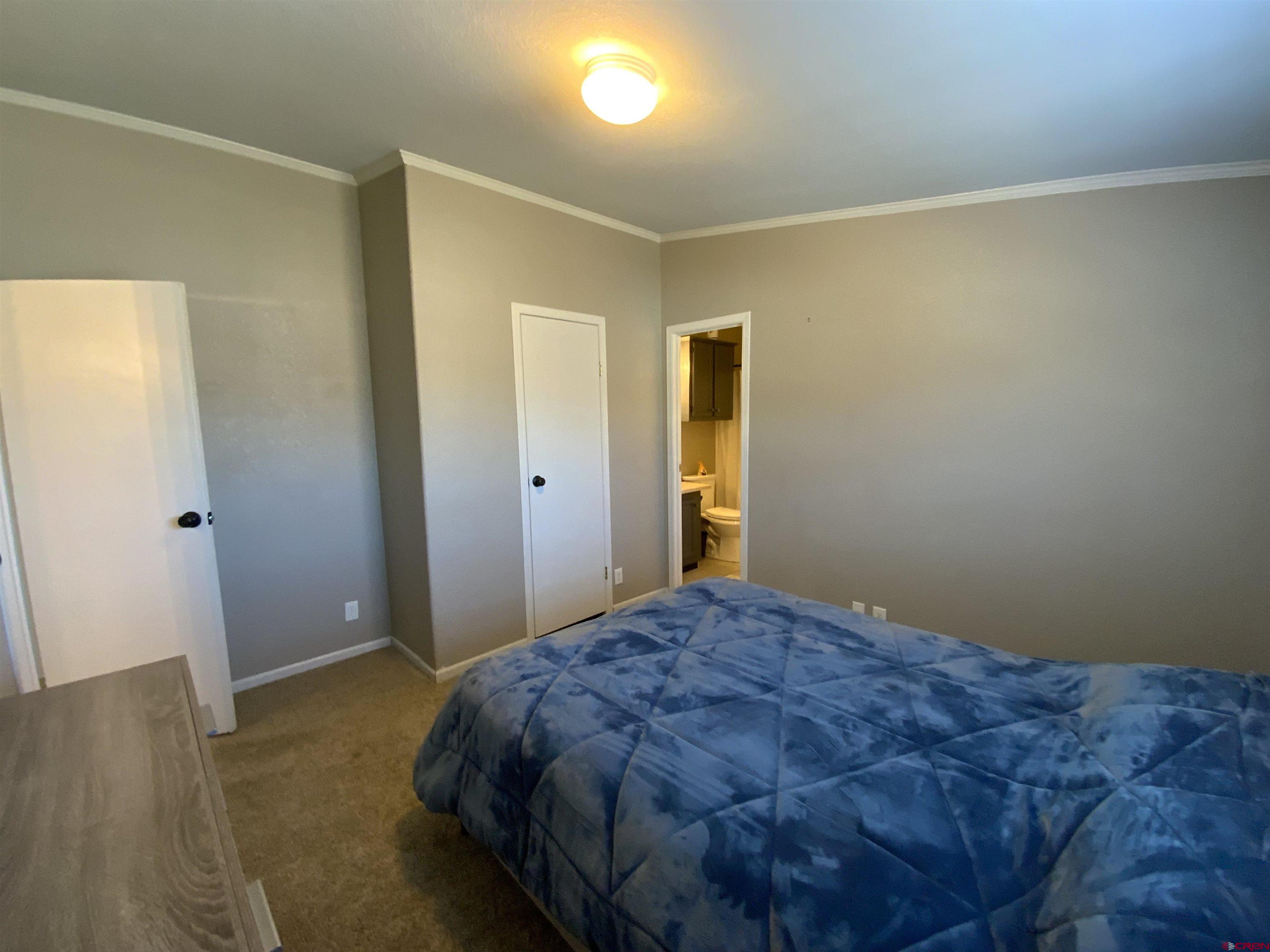 13 Ridge Lane Gunnison, CO 81230 - Photo 19 of 24 a bedroom with a bed and wooden floor