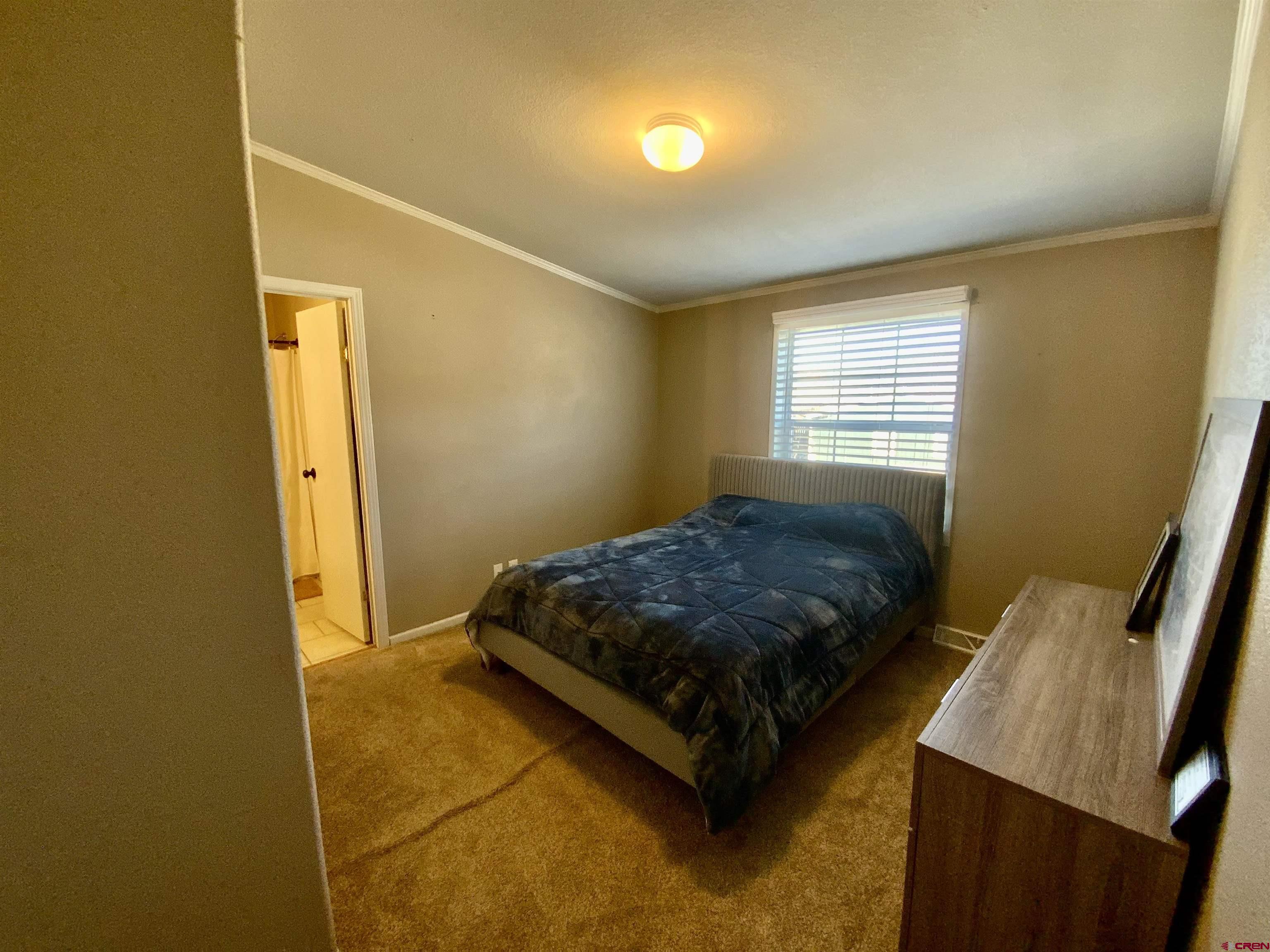 13 Ridge Lane Gunnison, CO 81230 - Photo 20 of 24 a bedroom with a bed and a window