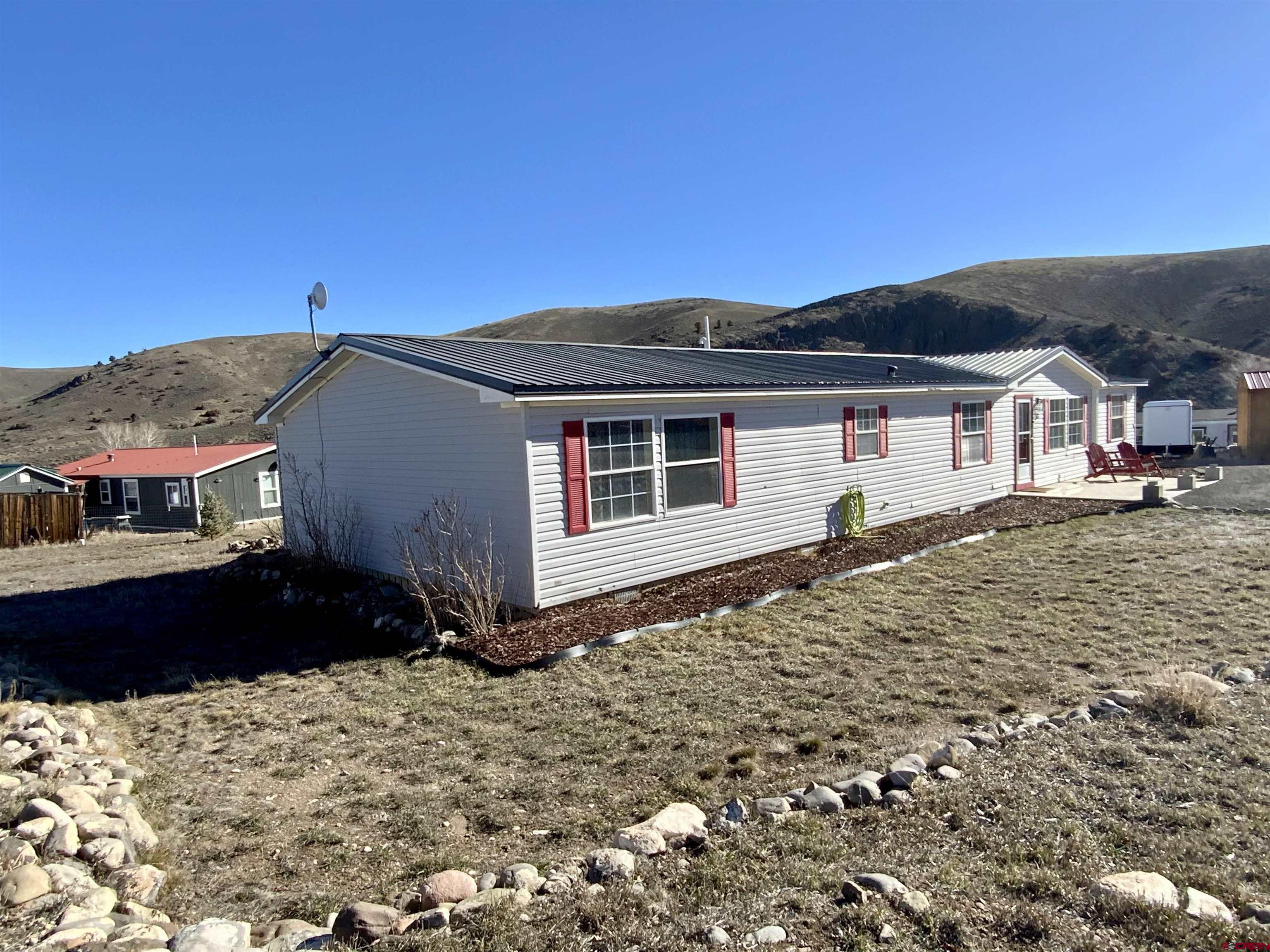13 Ridge Lane Gunnison, CO 81230 - Photo 2 of 24 a front view of a house with a yard