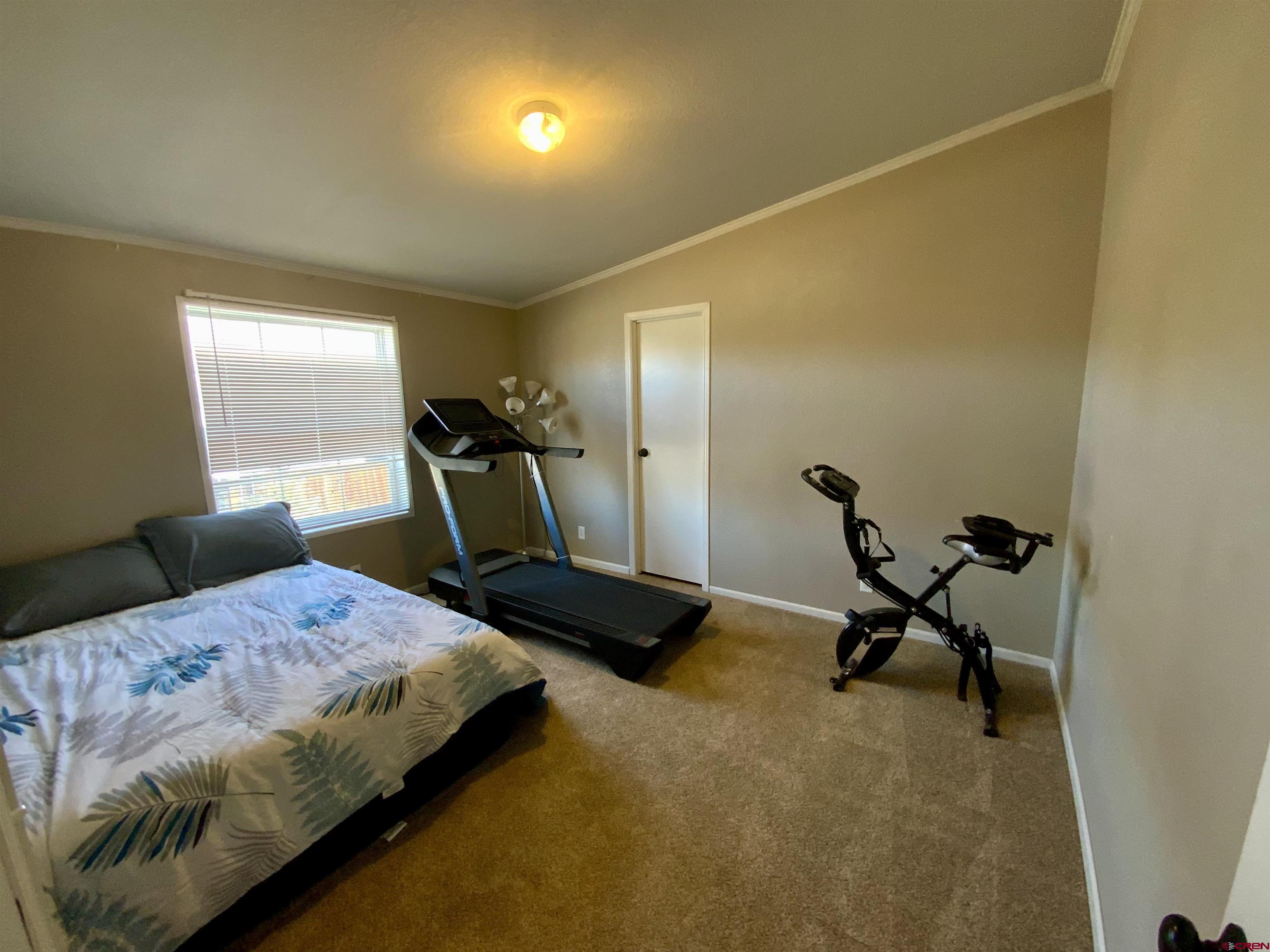 13 Ridge Lane Gunnison, CO 81230 - Photo 22 of 24 a bedroom with a bed and a large mirror