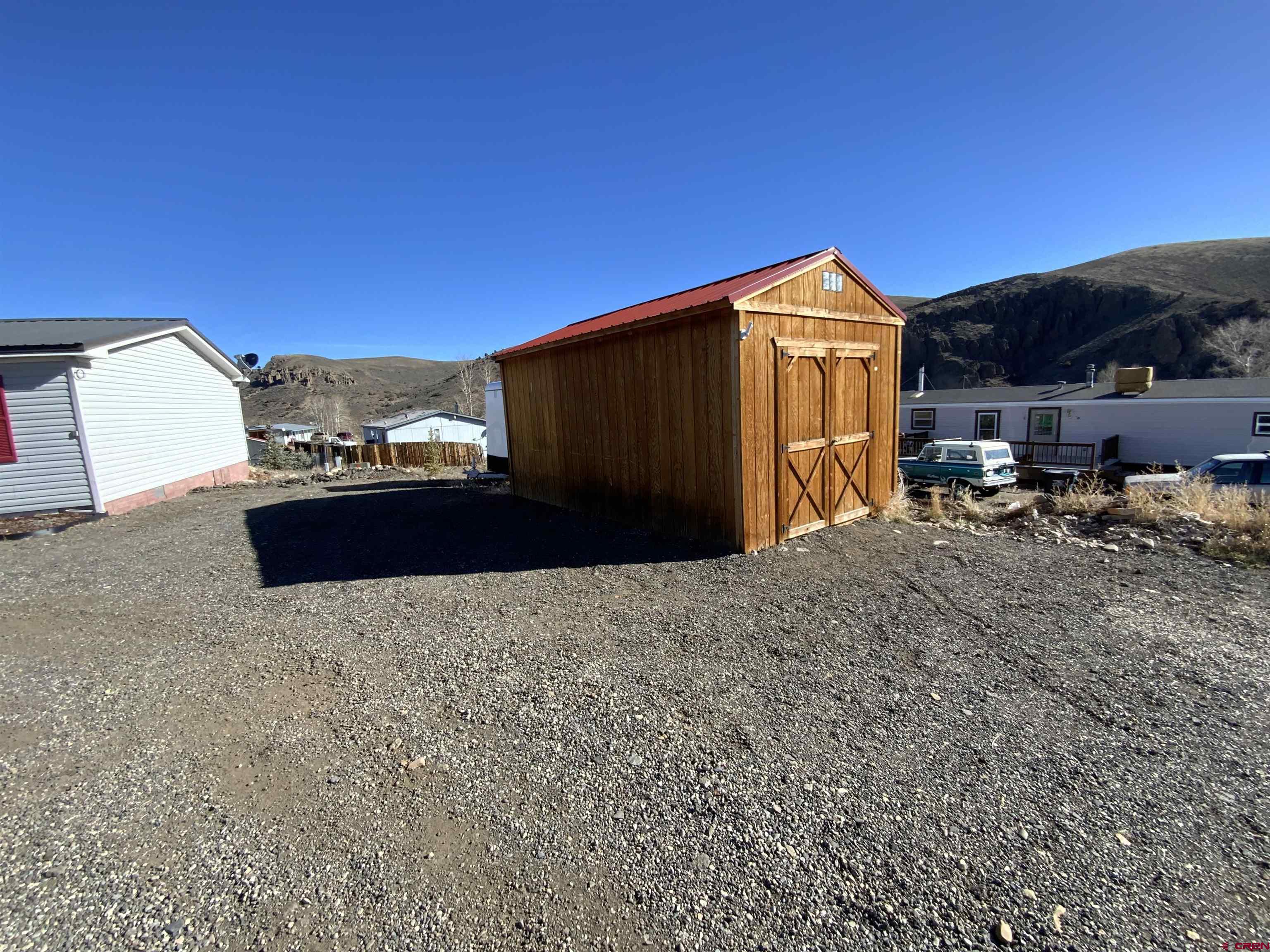13 Ridge Lane Gunnison, CO 81230 - Photo 4 of 24 a backyard of a house with table and chairs