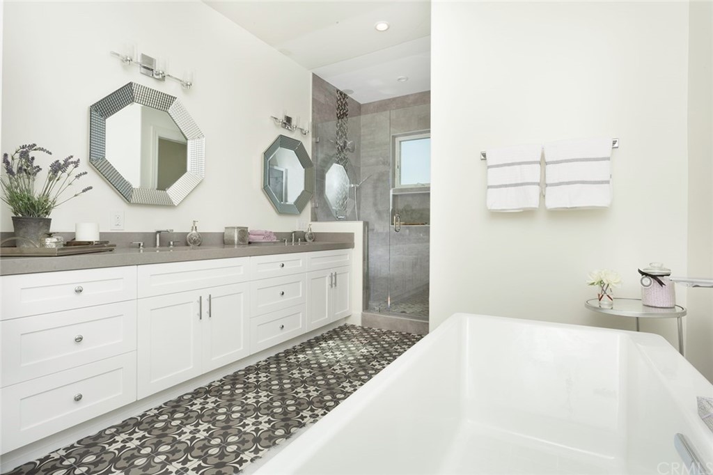631 North Lucerne Boulevard Los Angeles, CA 90004 - Photo 11 of 21 a spacious bathroom with a double vanity sink and a mirror