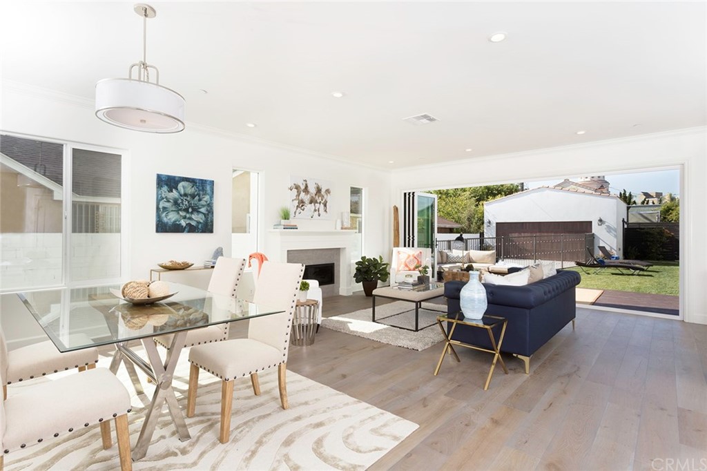631 North Lucerne Boulevard Los Angeles, CA 90004 - Photo 3 of 21 a living room with furniture a dining table and a fireplace