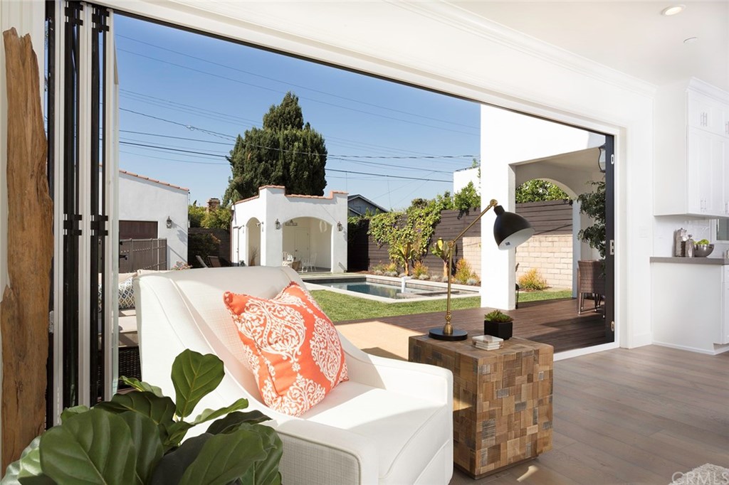 631 North Lucerne Boulevard Los Angeles, CA 90004 - Photo 7 of 21 a living room with fireplace furniture and a potted plant