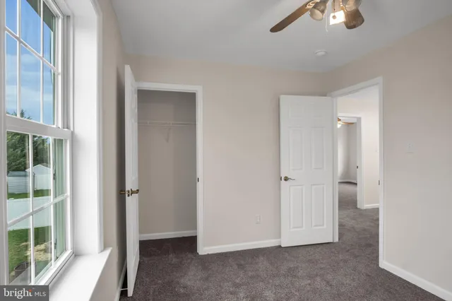 an empty room with windows and entrance