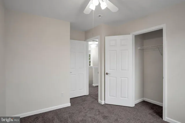 an empty room with a empty space and a ceiling fan