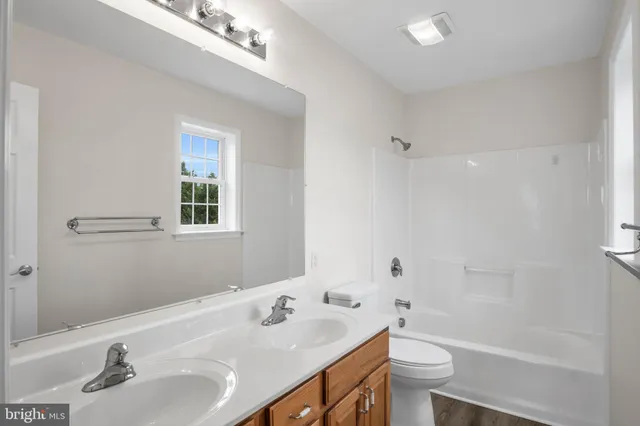 a bathroom with a sink toilet a tub and shower
