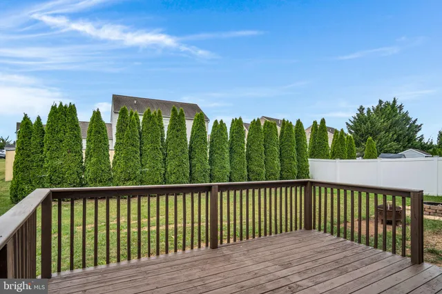 a balcony with wooden floor and fence
