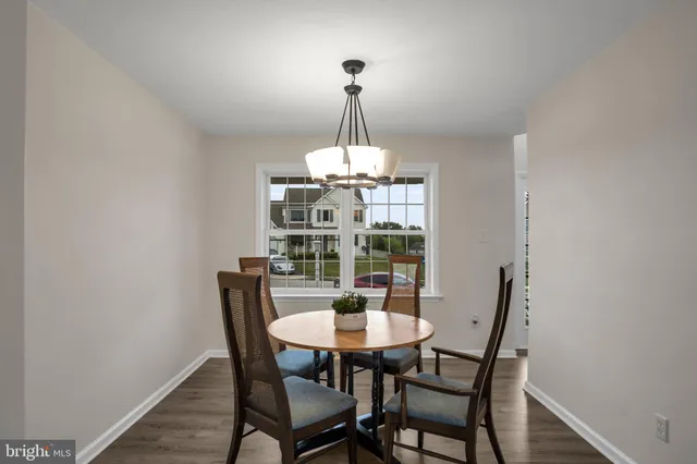 a dining room with a table and chairs