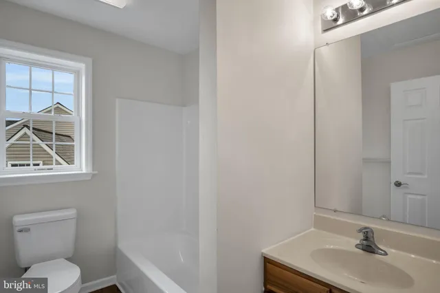 a bathroom with a sink toilet and a mirror
