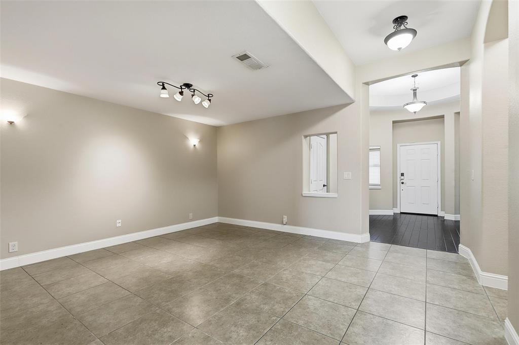 5224 Smokey Ridge Drive Fort Worth, TX 76123 - Photo 12 of 36 wooden floor in an empty room with a window