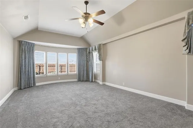 a view of a livingroom with a ceiling fan and window