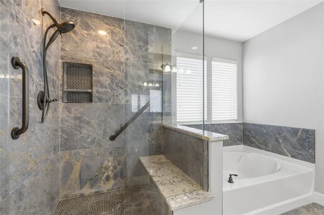 a bathroom with a bathtub and a shower