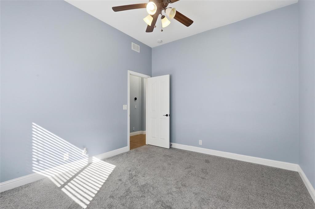 5224 Smokey Ridge Drive Fort Worth, TX 76123 - Photo 25 of 36 an empty room with a ceiling fan and carpet