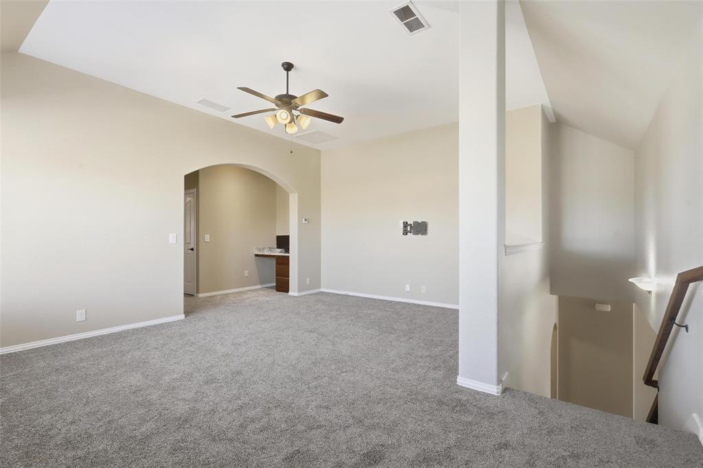 5224 Smokey Ridge Drive Fort Worth, TX 76123 - Photo 26 of 36 a view of a room with a ceiling fan and a bathroom