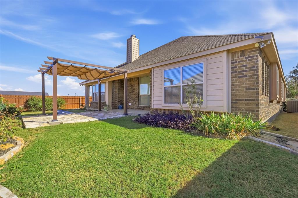 5224 Smokey Ridge Drive Fort Worth, TX 76123 - Photo 32 of 36 a front view of a house with garden