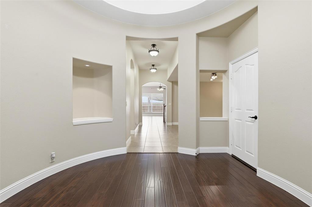 5224 Smokey Ridge Drive Fort Worth, TX 76123 - Photo 4 of 36 wooden floor in an empty room with a window