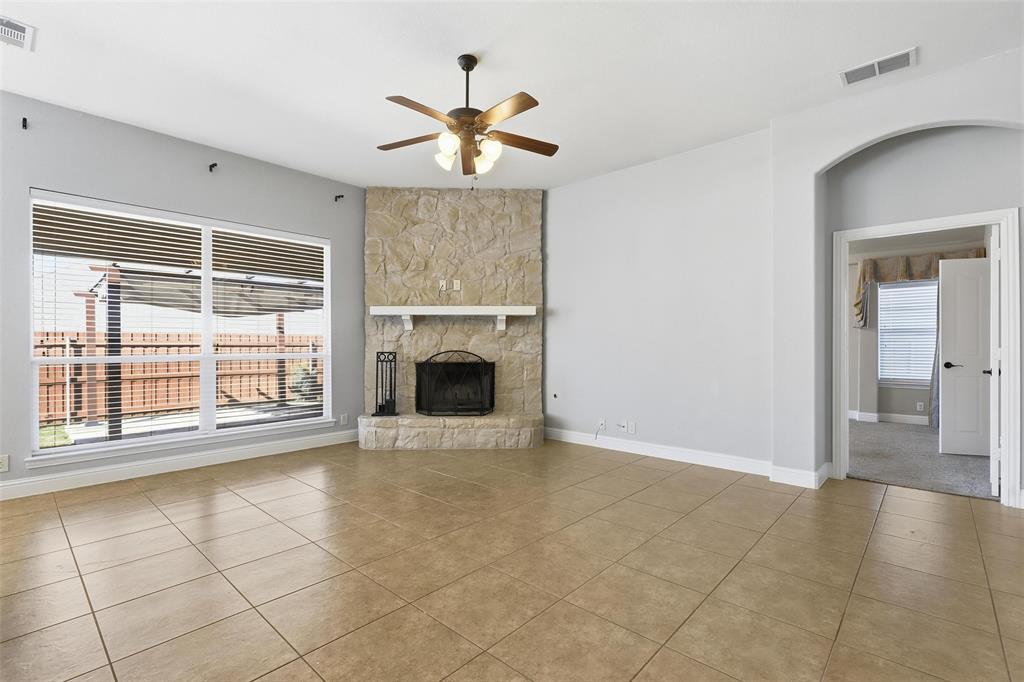 5224 Smokey Ridge Drive Fort Worth, TX 76123 - Photo 6 of 36 a view of an empty room with a fireplace and a window