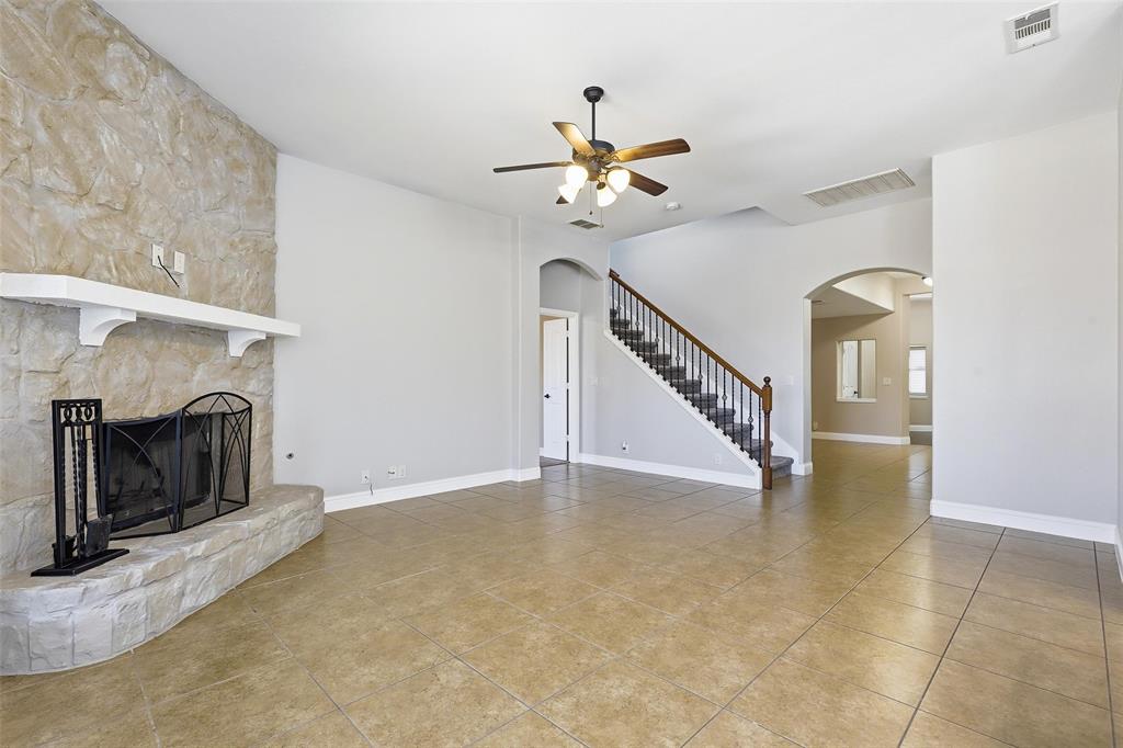 5224 Smokey Ridge Drive Fort Worth, TX 76123 - Photo 7 of 36 a view of an empty room with chandelier fan and fire place
