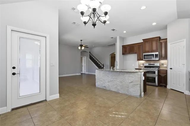 a view of kitchen with microwave and cabinets