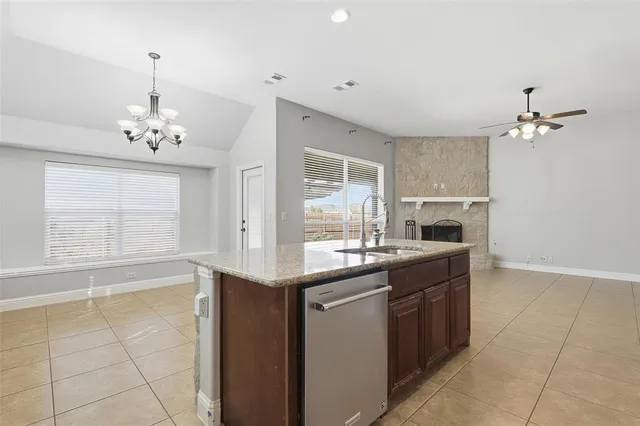 a kitchen with stainless steel appliances a sink stove and cabinets