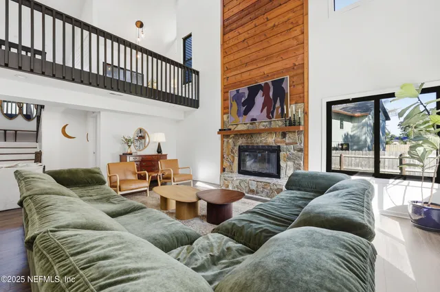 a living room with furniture ceiling fan and a fireplace