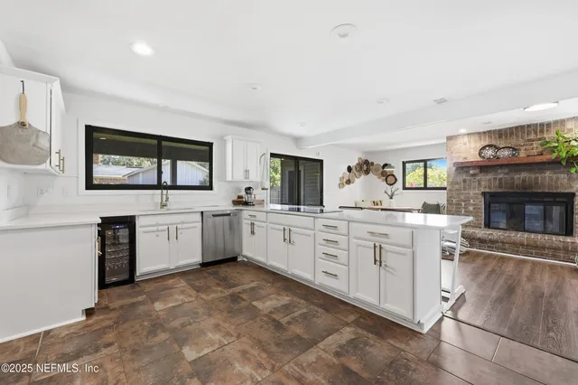 a kitchen with white cabinets and appliances