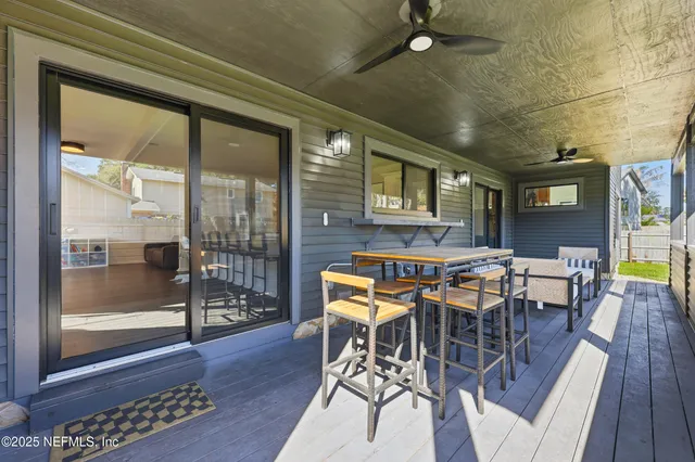 a dining room with furniture a chandelier and wooden floor