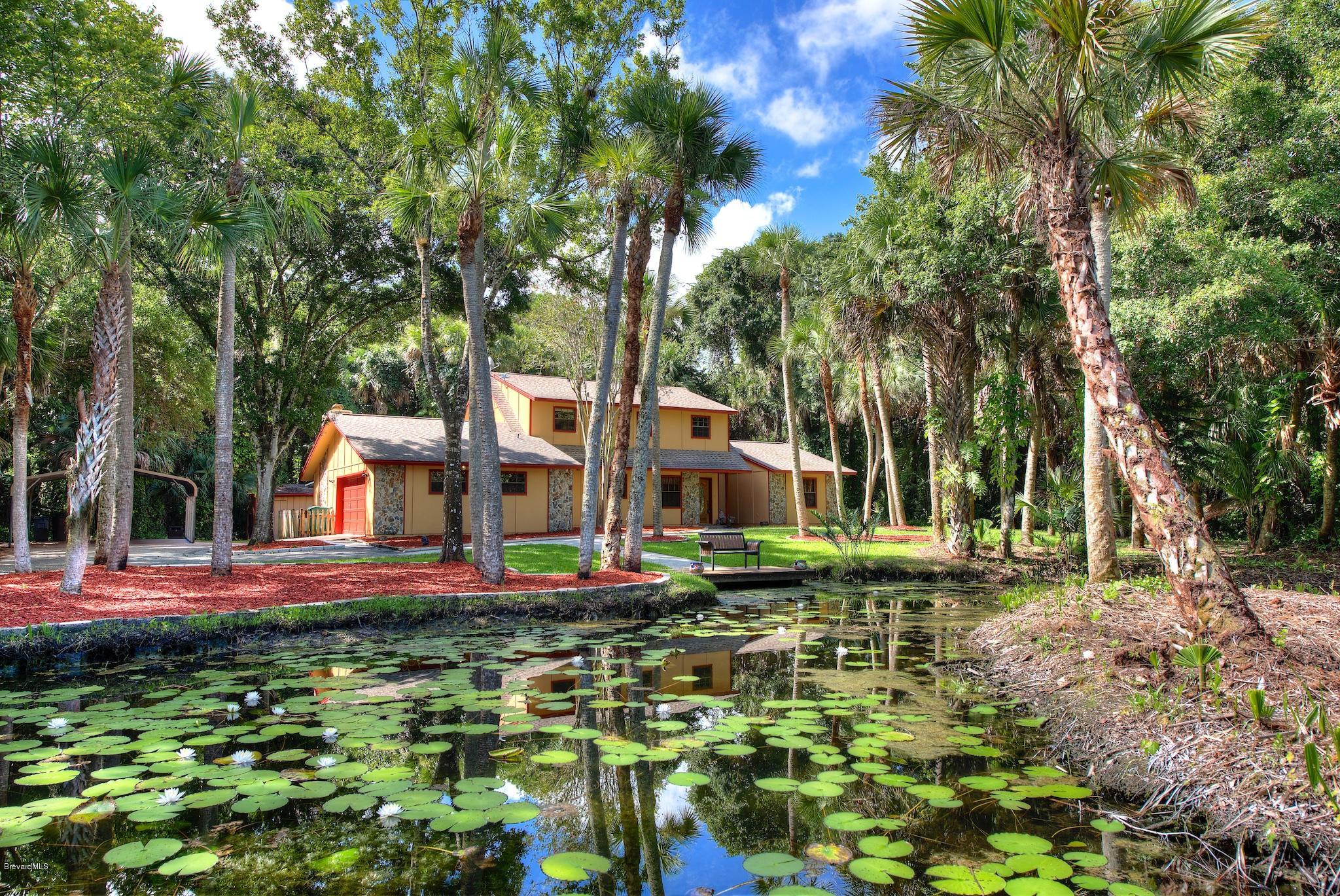 4465 Country Road Melbourne, FL 32934 - Photo 1 of 25 DRIVE WAY AROUND POND