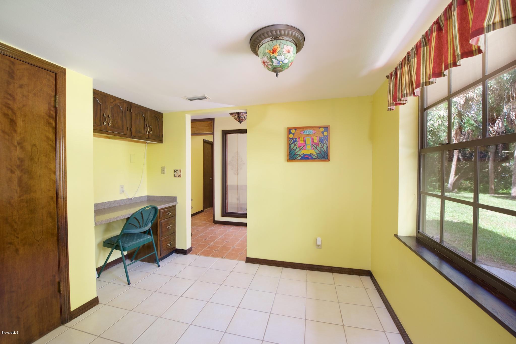 4465 Country Road Melbourne, FL 32934 - Photo 6 of 25 FRONT ENTRANCE KITCHEN NOOK SPACE