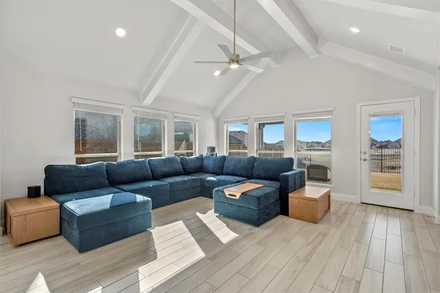 a bedroom with a bed couch and dresser