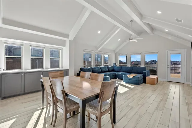 a dining area with stainless steel appliances kitchen island granite countertop a dining table chairs and granite counter tops