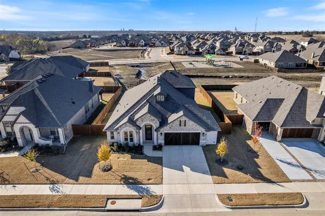 an aerial view of a house with a yard garage and a couch