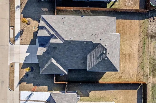 an aerial view of a house with a yard