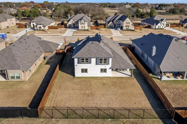 an aerial view of a house with a swimming pool