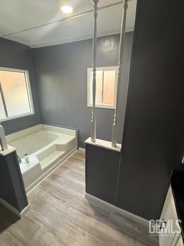 a bathroom with a tub sink and vanity