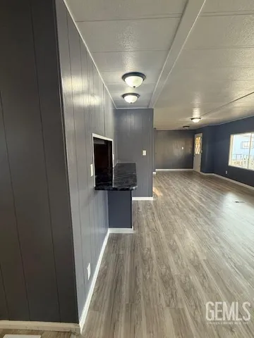 a view of a room with wooden floor