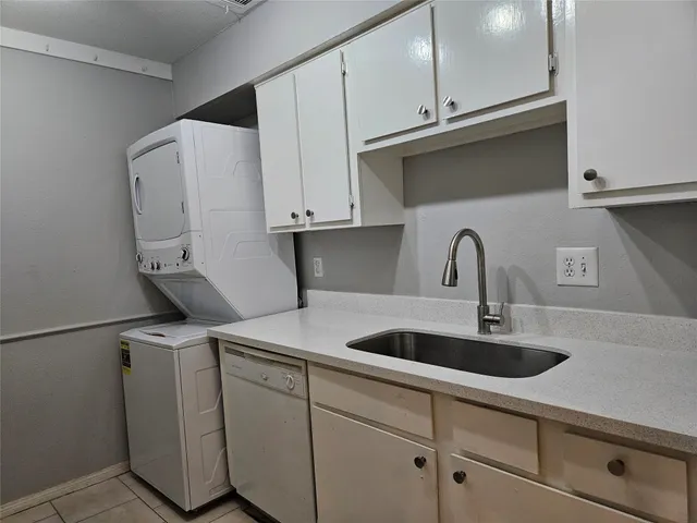 a kitchen with stainless steel appliances granite countertop a sink and a white cabinets