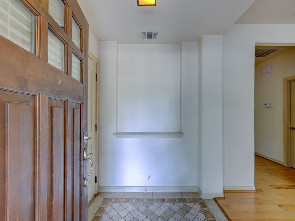 9707 Anderson Mill Road, Unit 22 Austin, TX 78750 - Photo 8 of 39 A welcoming entry features a rich wood front door and warm tiled flooring.